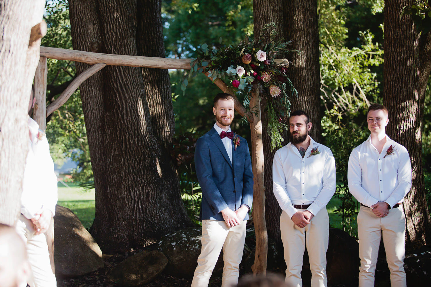 Groom-waiting-at-floral-arbour-ewingsdale-dall-Byron_Bay-Wedding-QuincenmulberryStudios