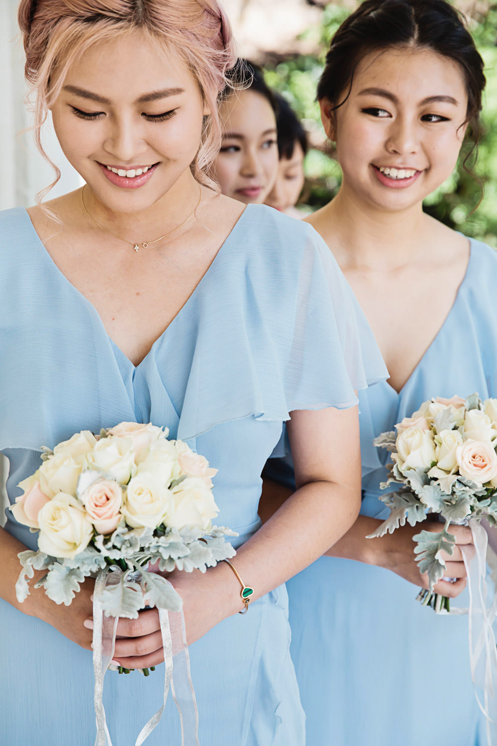 bridesmaids-wearing-blue-dresses-waiting-to-enter-the-chapel_Sanctuary-cove-wedding-photography_quincenmulberrystudios