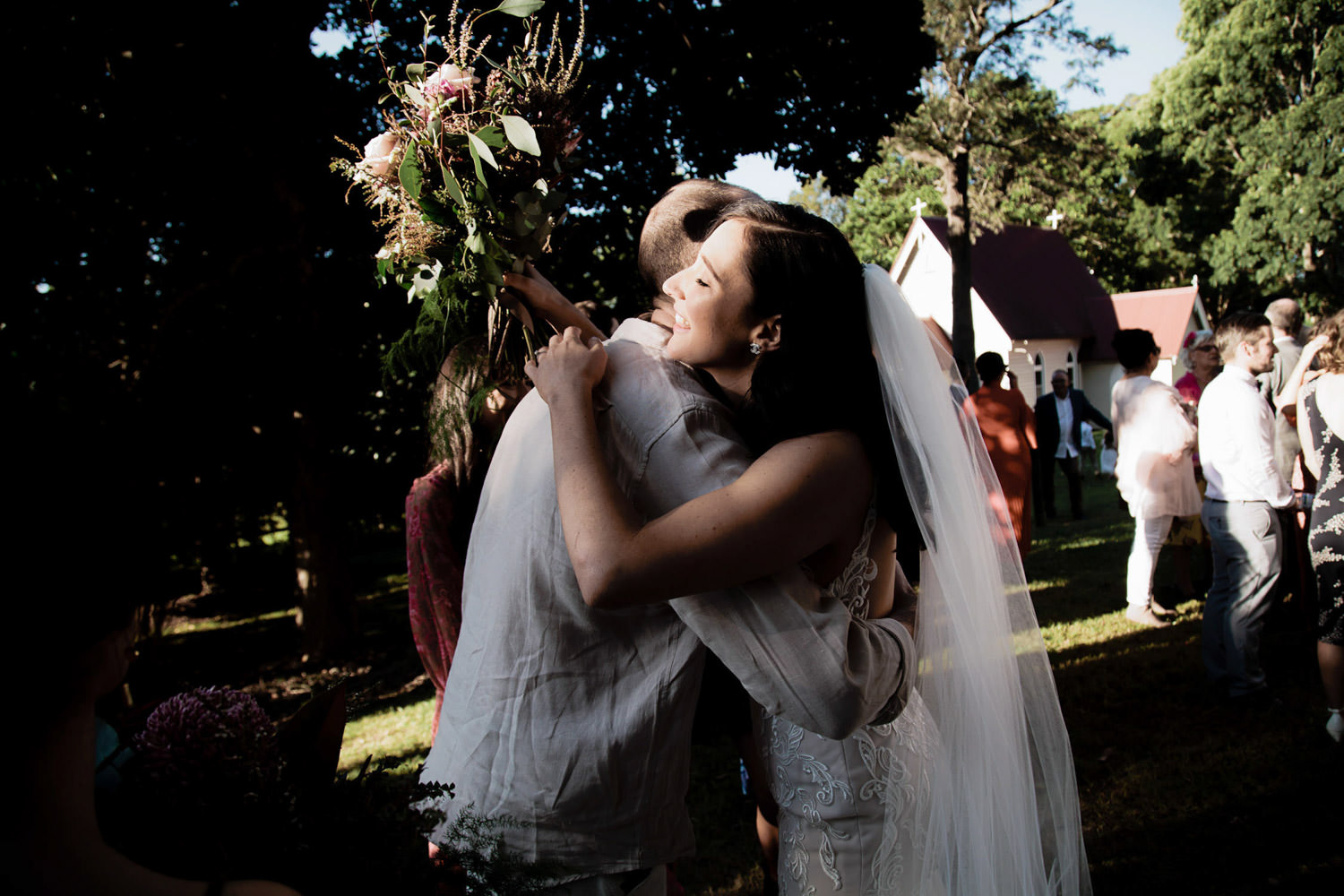 candid-moment-hugs-and-kisses_Ewingsdale-Hall_Byron_Bay-Wedding-QuincenmulberryStudios
